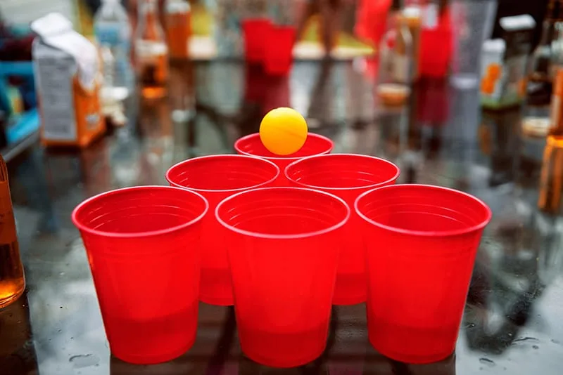 six red cups and yellow ping pong ball setup for beer game