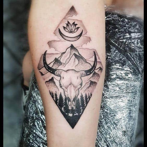 skull in a rhombus tattoo on the arm