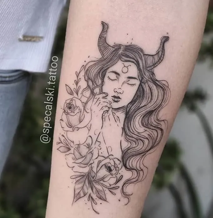 sleepy girl with bulls horns tattoo on the arm