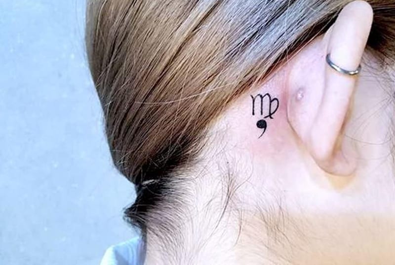 small Virgo symbol with comma tattoo behind the ear