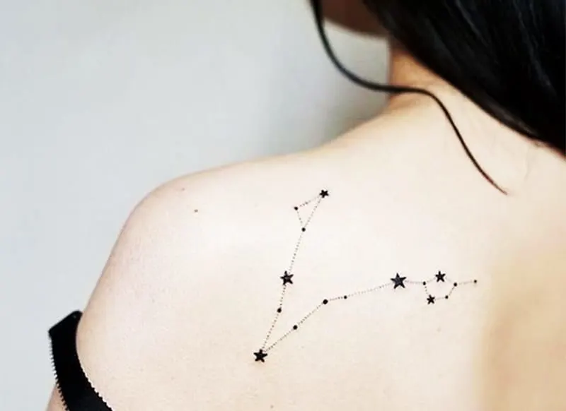 stars aligment tattoo on woman`s shoulder