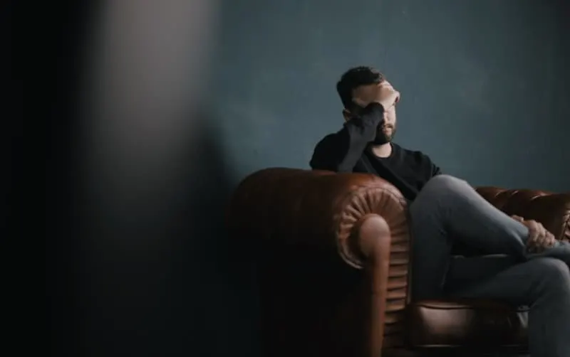 Stressed man sitting on a couch