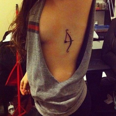 styled bow and arrow tattoo on the woman`s body