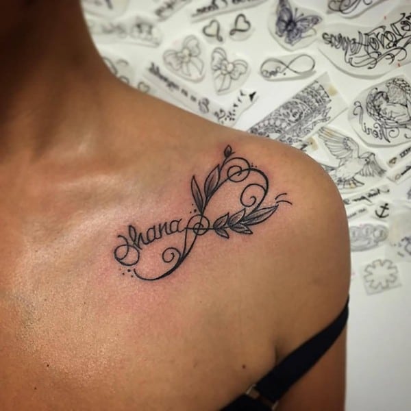 swirly name tattoo on shoulder