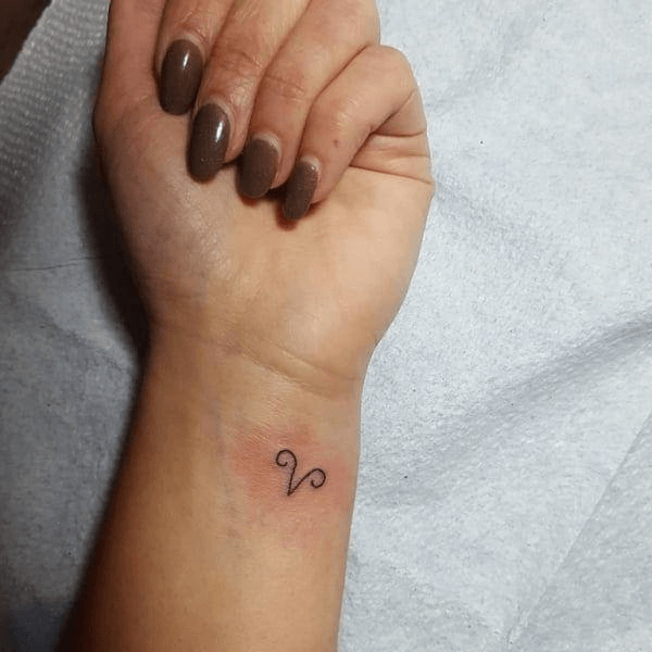 symbol of Aries tattoo on wrist