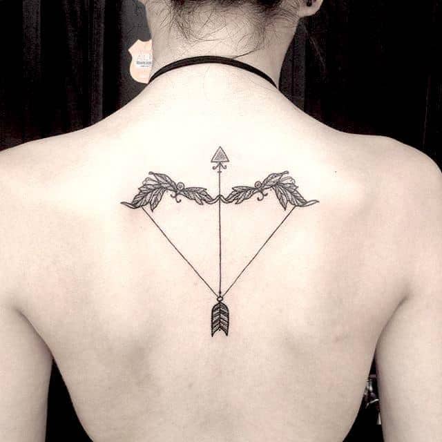 Infinity arrow tattoo on Veronikas upper back