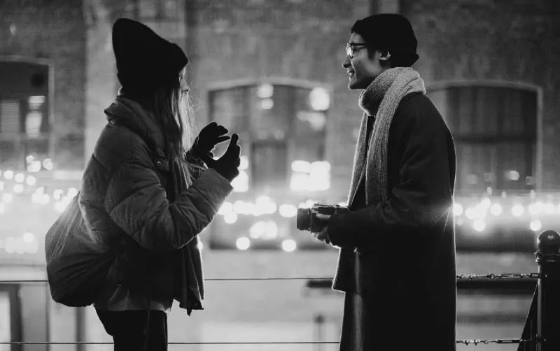 talking man and woman on the street in the evening