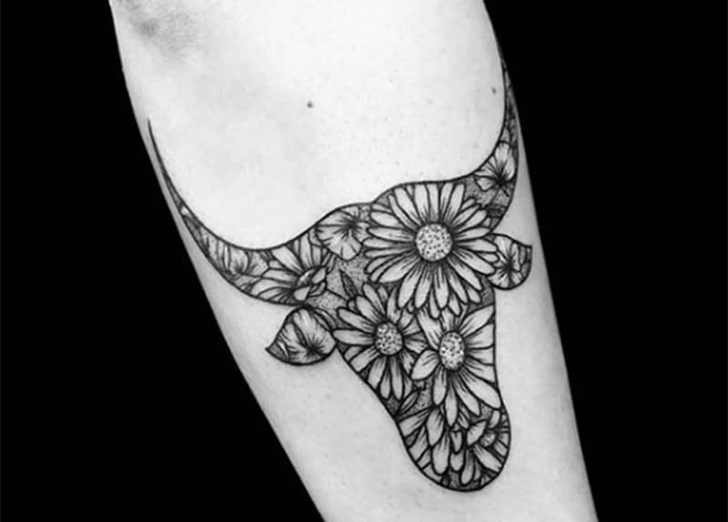 tatuaje de tauro con diseño floral en el brazo