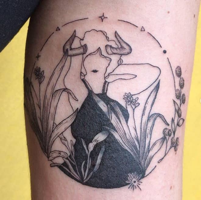 taurus woman tattoo surrounded with flowers