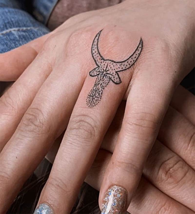 taurus zodiac symbol on finger