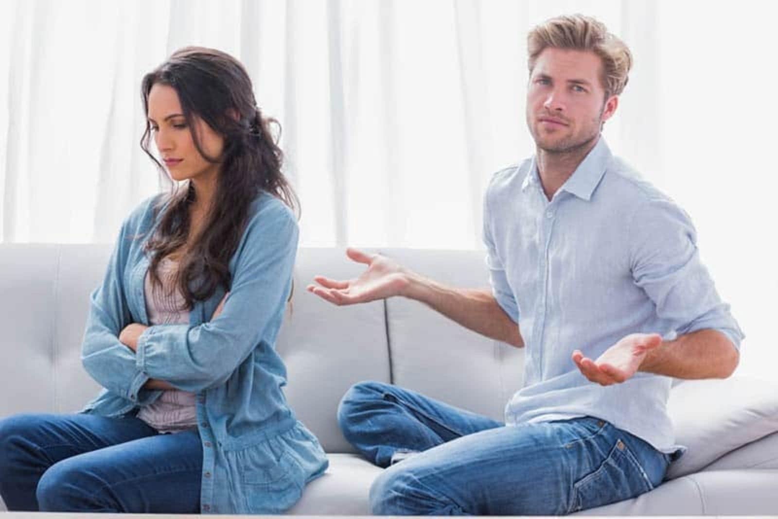 the man looks at the woman in confusion as she turns her back on him