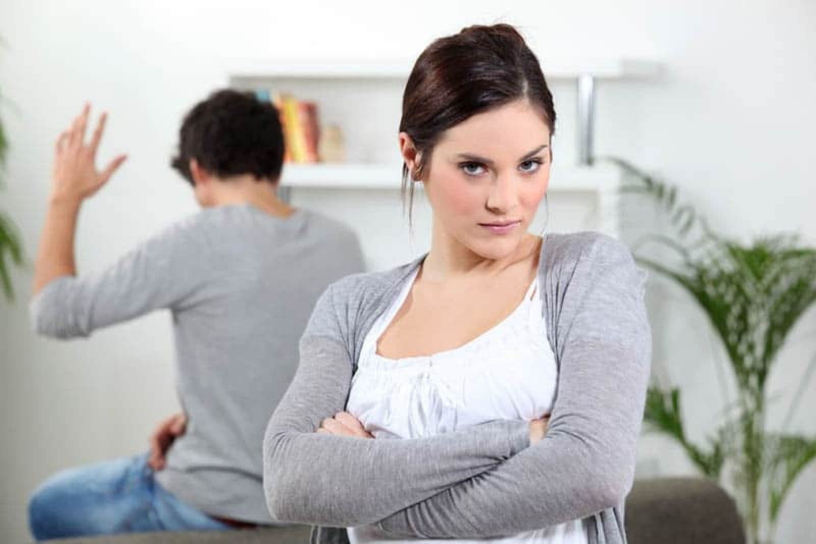 the man waves his hand to the woman turning his back on him