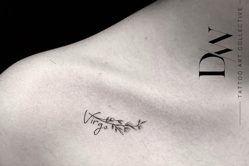the word Virgo tattoo with small flowers