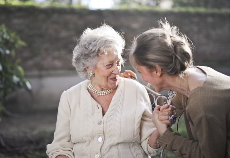 due donne adulte una accanto all'altra che sorridono