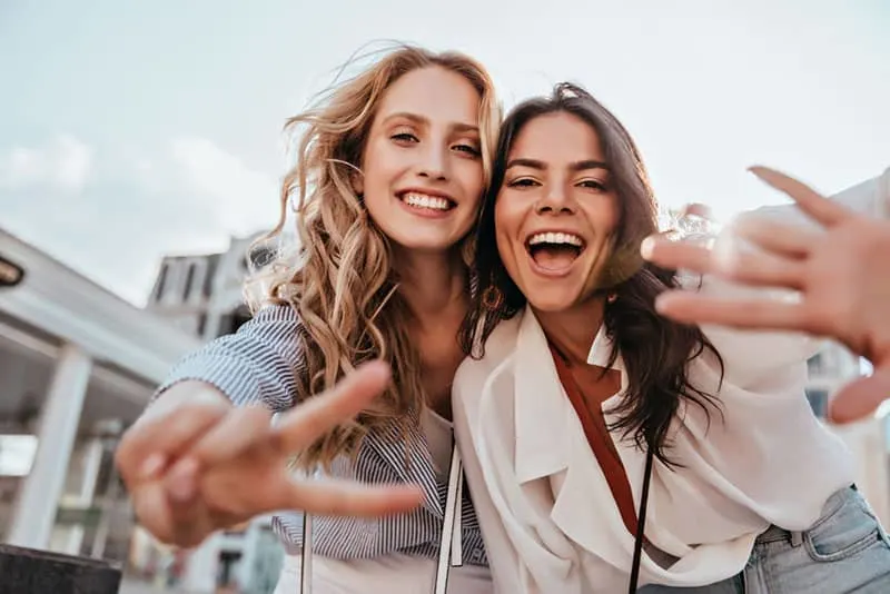 two friends posing at camera