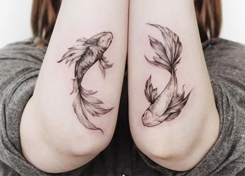 two pisces tattoo on the elbows