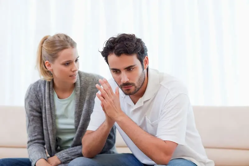 unhappy couple sitting on sofa