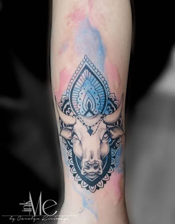 watercolor taurus tattoo on the arm