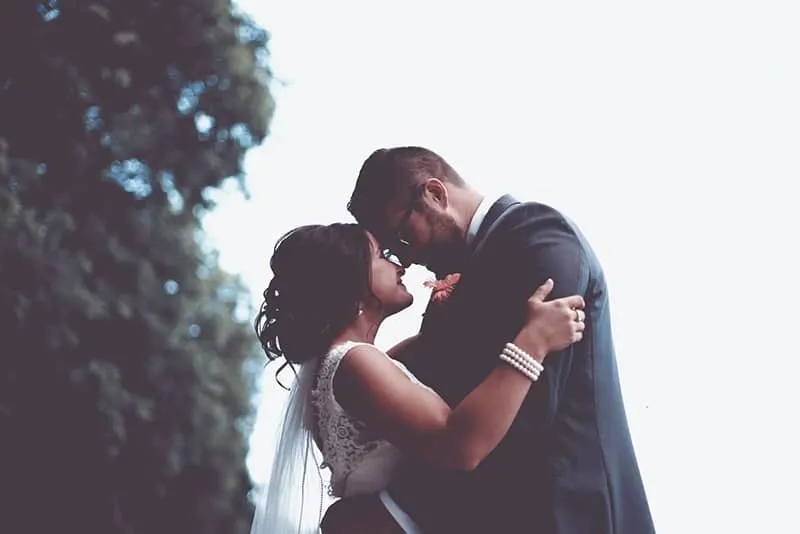 wedding couple standing outdoor and looking each other