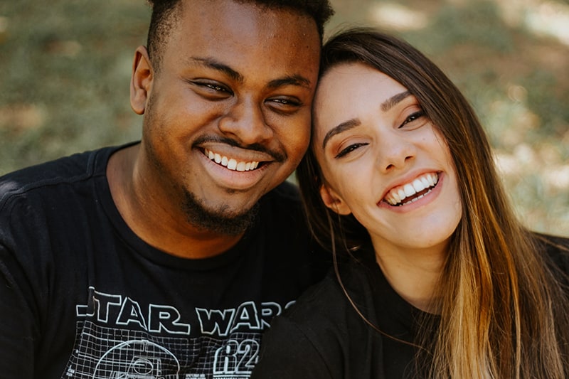 woman and man wearing black shirts laughing together