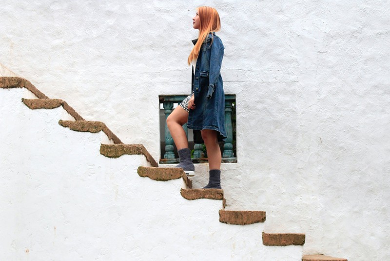 donna che sale su scale di cemento marrone senza recinzione