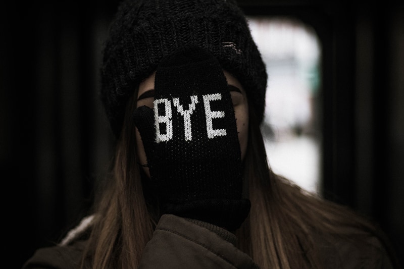 woman covering her face with black glove