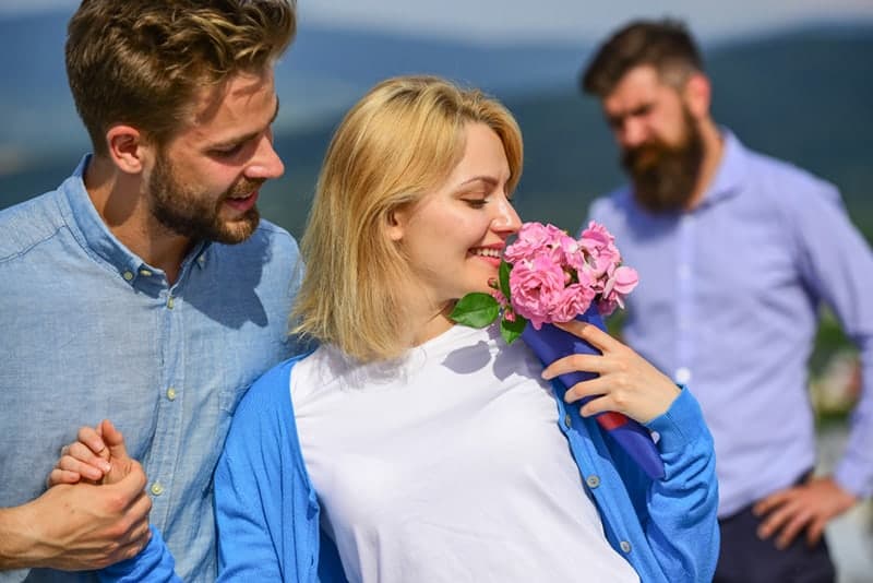 woman gets flowers from man