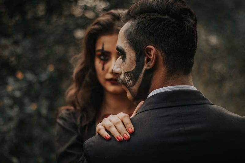 man and woman with halloween print on face 