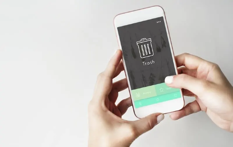 Woman hands holding phone with trash message