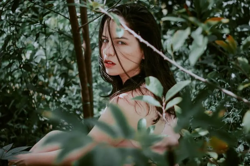 woman in green leaves