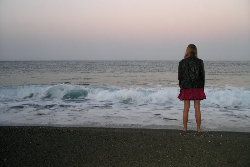 woman in leather jacket on the beach