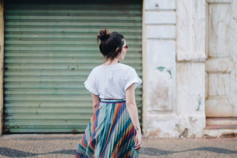 woman standing in front of green roller-shutter