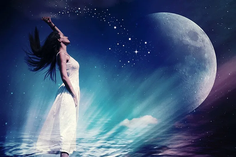 woman in white dress under the moon and the stars