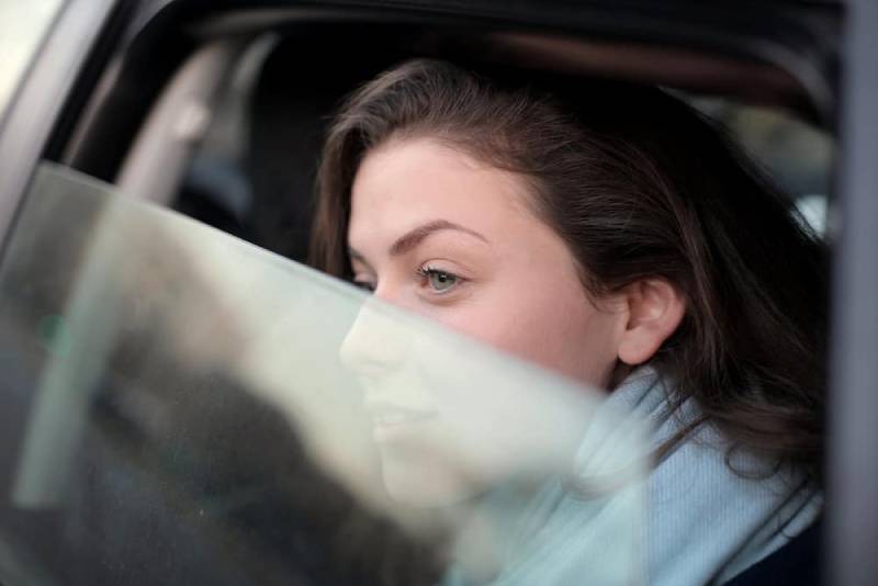 woman looking out the car window