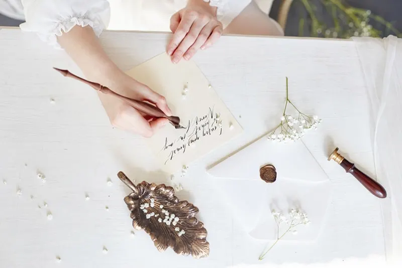 Woman write love letter on white table