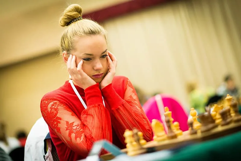 Woman in red playing chess