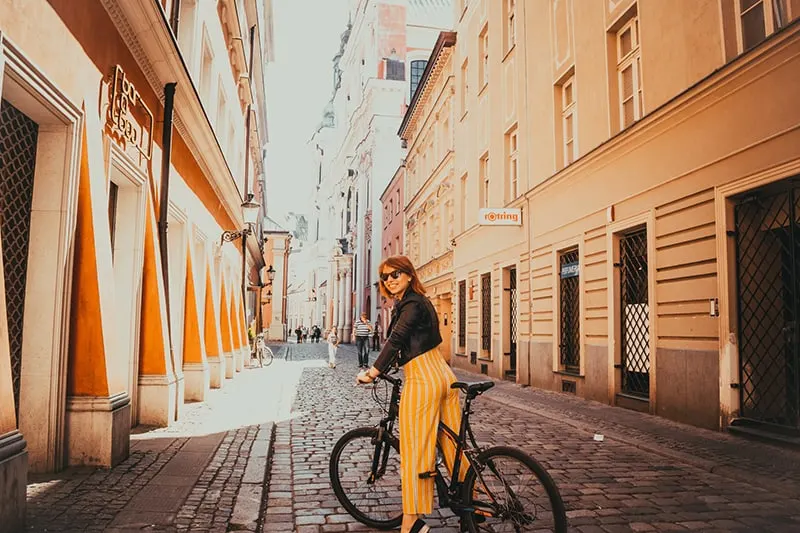woman riding black bike in empty street