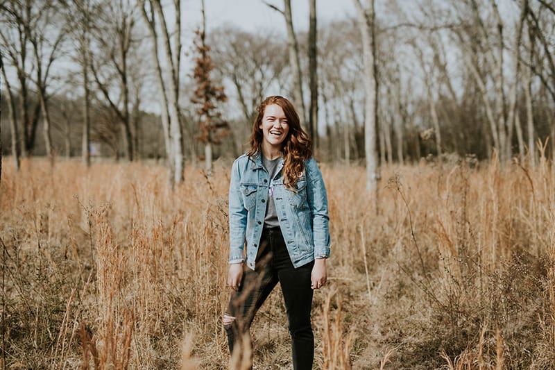 woman standing at forest while smiling