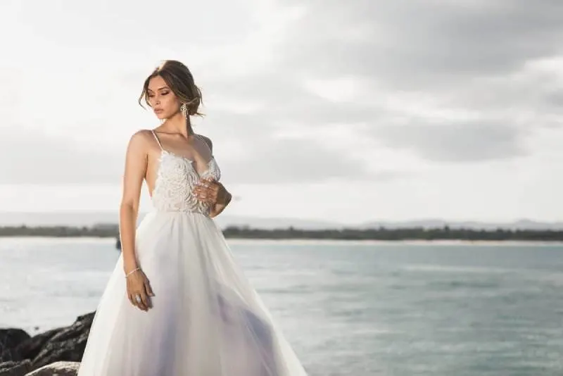 woman standing beside body of water