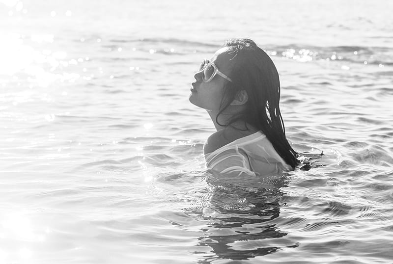 woman wearing sunglasses while swimming