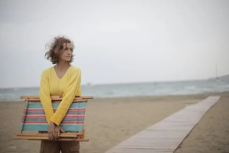 woman wearing wooden beach chair