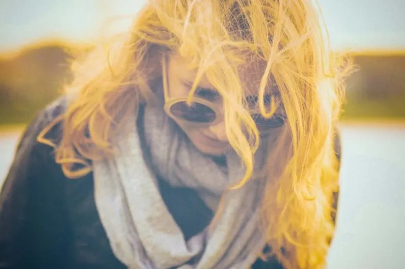 woman with black and grey scarf