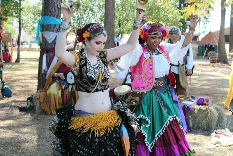 two women wearing gipsy costumes dancing