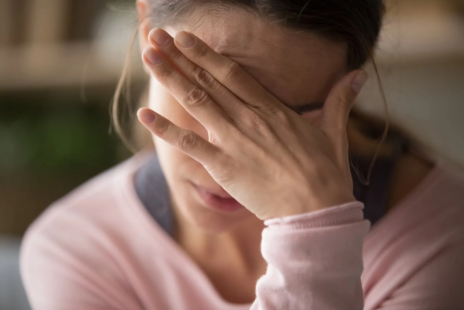 worried woman holding hand on the forehead