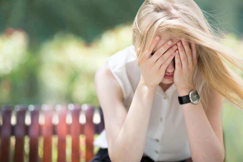 worried woman sitting on bench