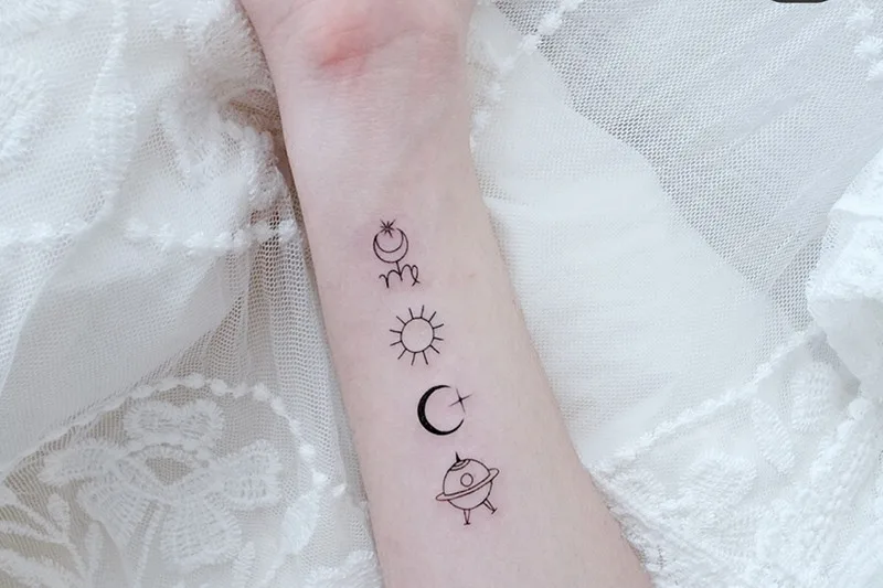 wrist tattoo with glyphs under the Virgo sign