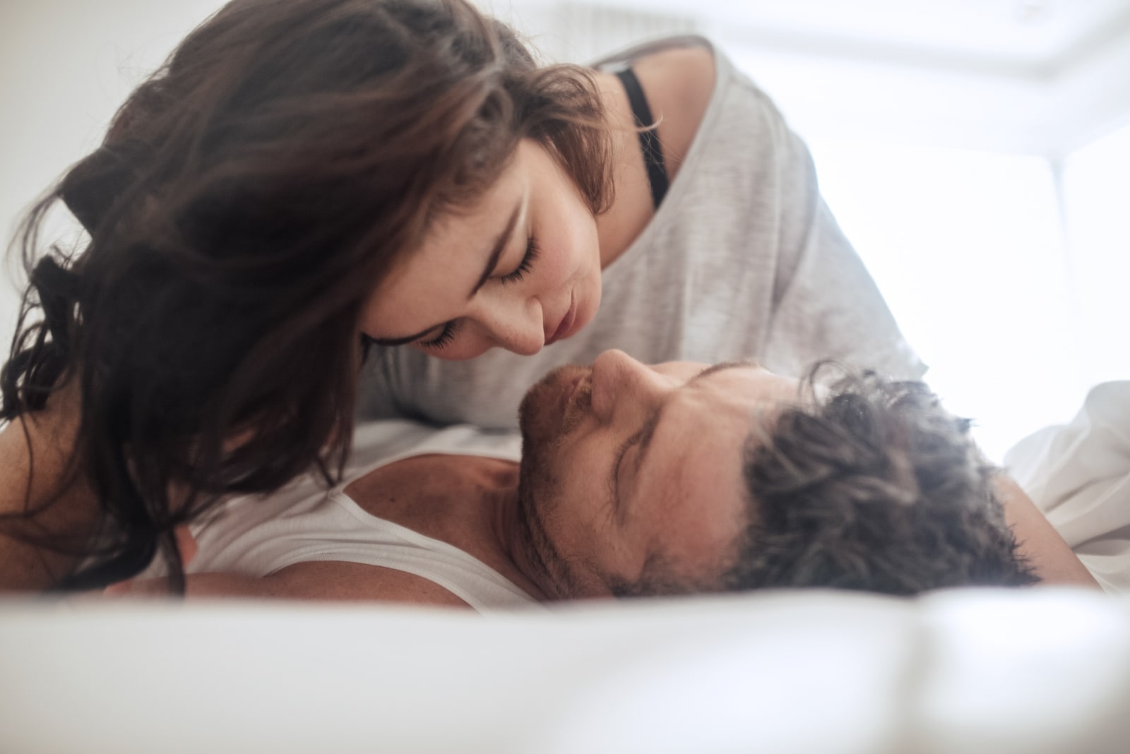 young woman gently kissing her boyfriend