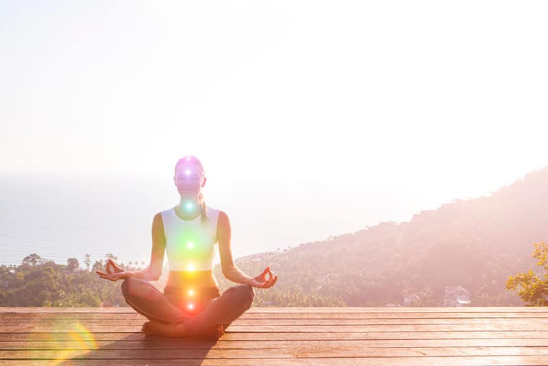 young woman meditates outdoor