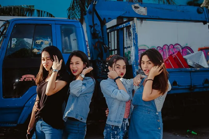 young women in casual wear standing in a front of truck