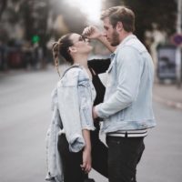 man and woman making eye contact while standing outdoor